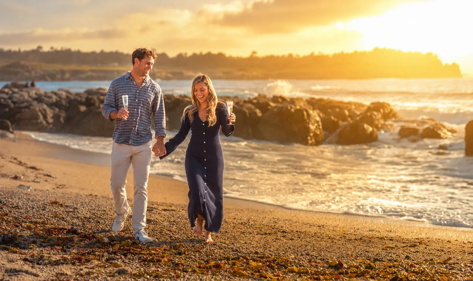 Couple on Ribera Beach at sunset after a Carmel proposal, photographed by Manny Espinoza