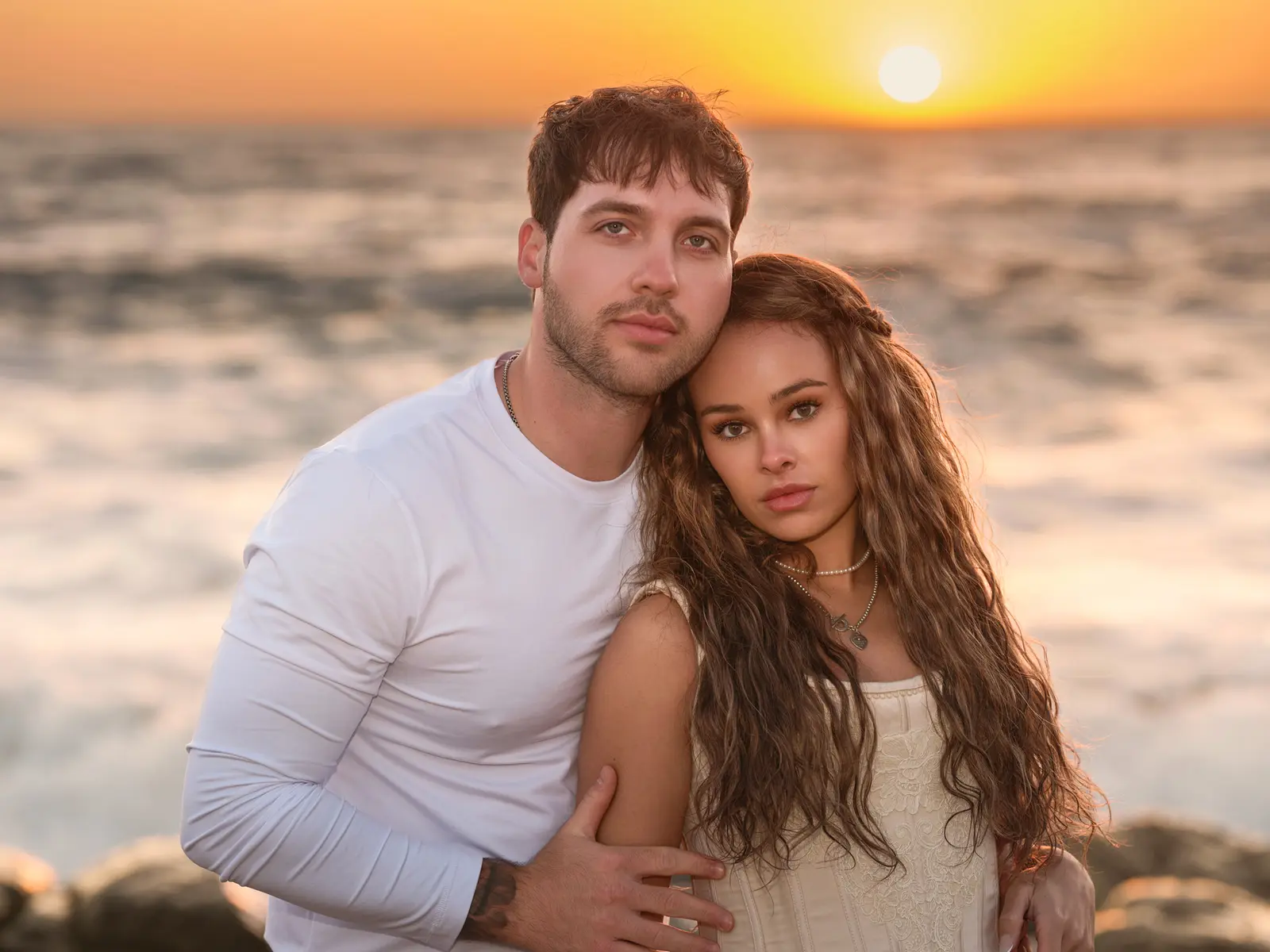 Engagement portrait of a couple at sunset on Ribera Beach, Carmel, photographed by Manny Espinoza